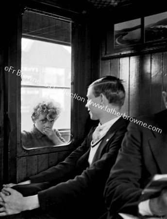 PASSENGER WITH CHILD LOOKING IN FROM CORRIDOR